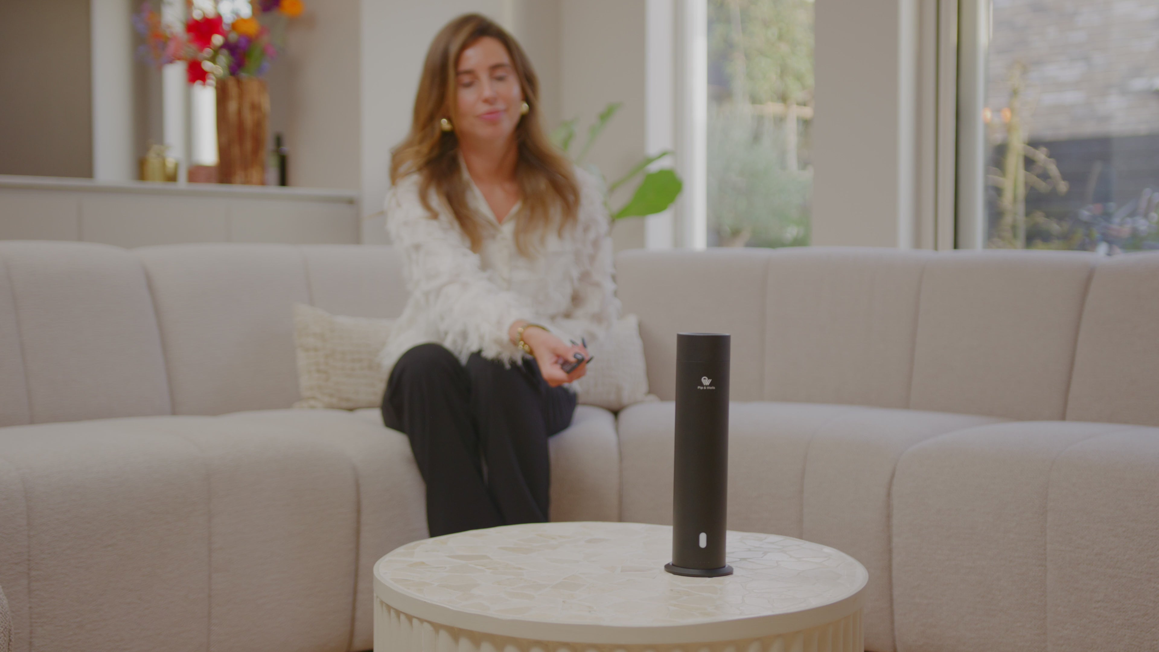 Pip & Wells Pure One matte black waterless aroma diffuser in a living room